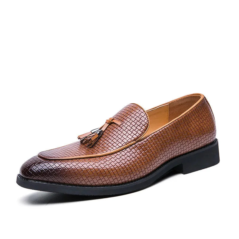 Men's black pointed slip-on business shoes with tassel detail on artificial PU upper.