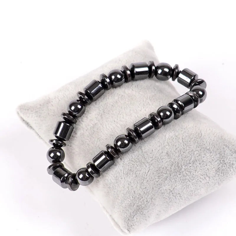 Black pentagram magnetic therapy bracelet made from magnetite and hematite stones with a stretch fit.