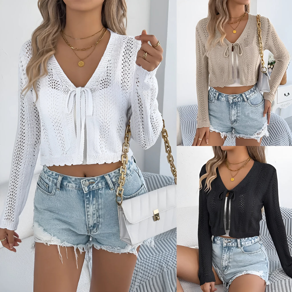 Women's short lace-up coat with hollow-out detail in black, shown in a casual streetwear setting.