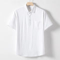 A man wearing a loose-fit linen-blend t-shirt in a solid colour with a relaxed lapel and short sleeves.