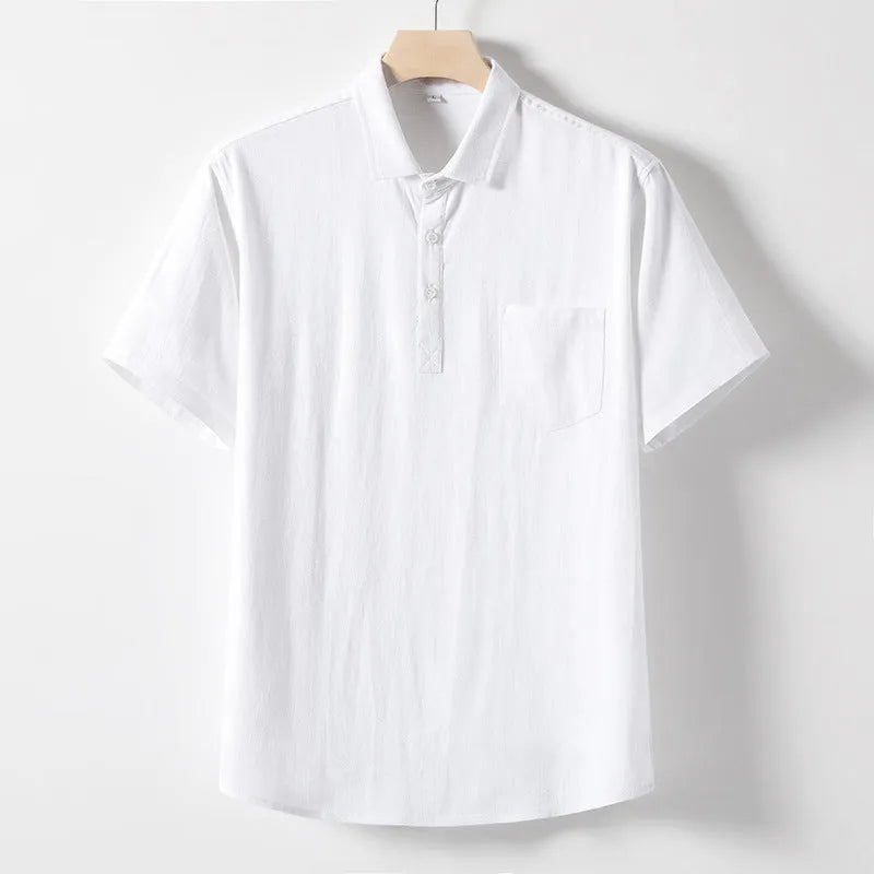 A man wearing a loose-fit linen-blend t-shirt in a solid colour with a relaxed lapel and short sleeves.