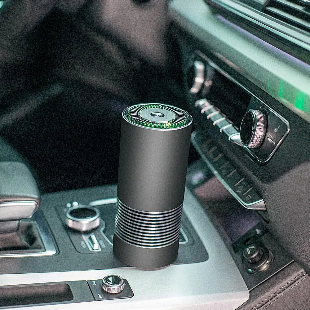 Compact wireless car air purifier in aluminium alloy and ABS, shown in black, silver, and metallic grey.