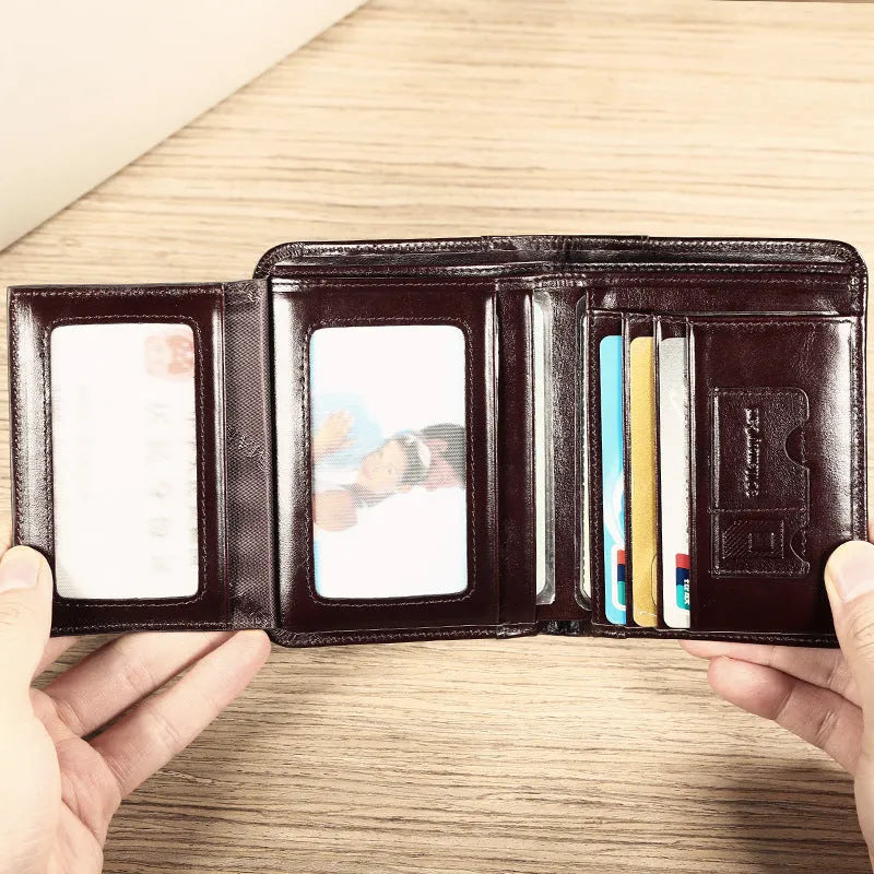 Men's black leather wallet open to show internal card slots, coin pocket, photo holder, and document section.