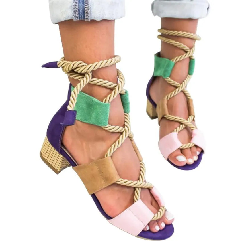 Women's beige suede sandals with fish-mouth toe, colour-matched pattern, and ankle strap on a thick heel.