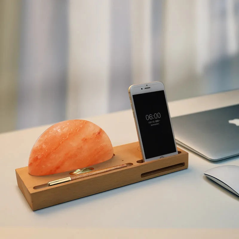 Natural crystal salt lamp with solid beech wood base and integrated Qi wireless phone charging pad.