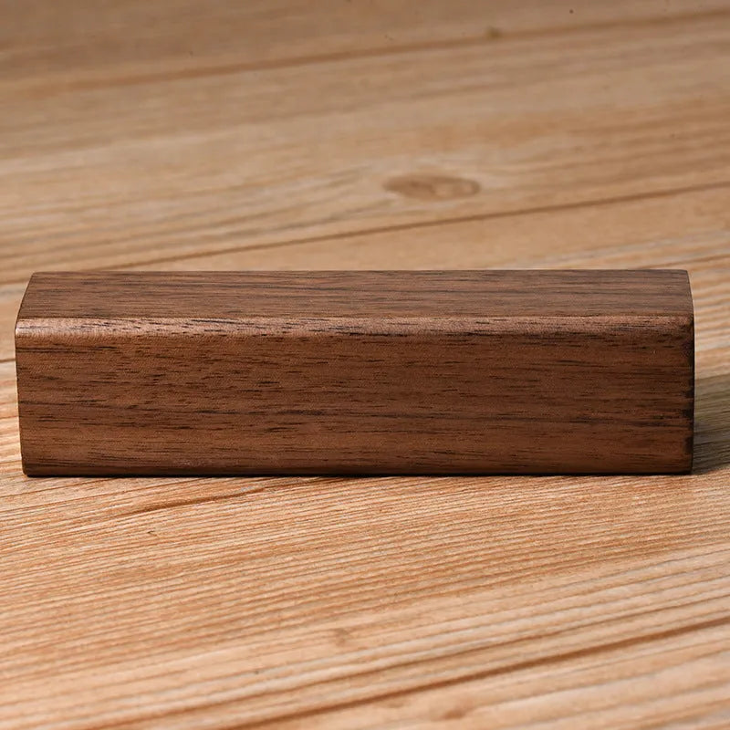 Brown walnut wood portable power bank showing its rectangular shape and natural wood grain.