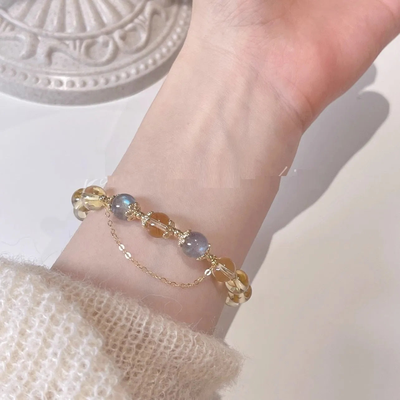 Chinese style crystal bracelet with diamond-shaped stones and gold electroplated finish.
