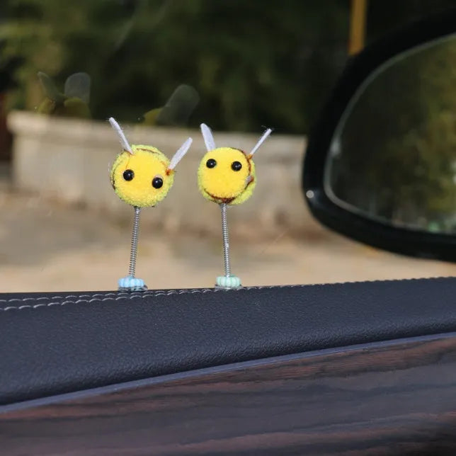 Swing spring bee car decoration made from soft fur ball, showing cartoon bee shape.