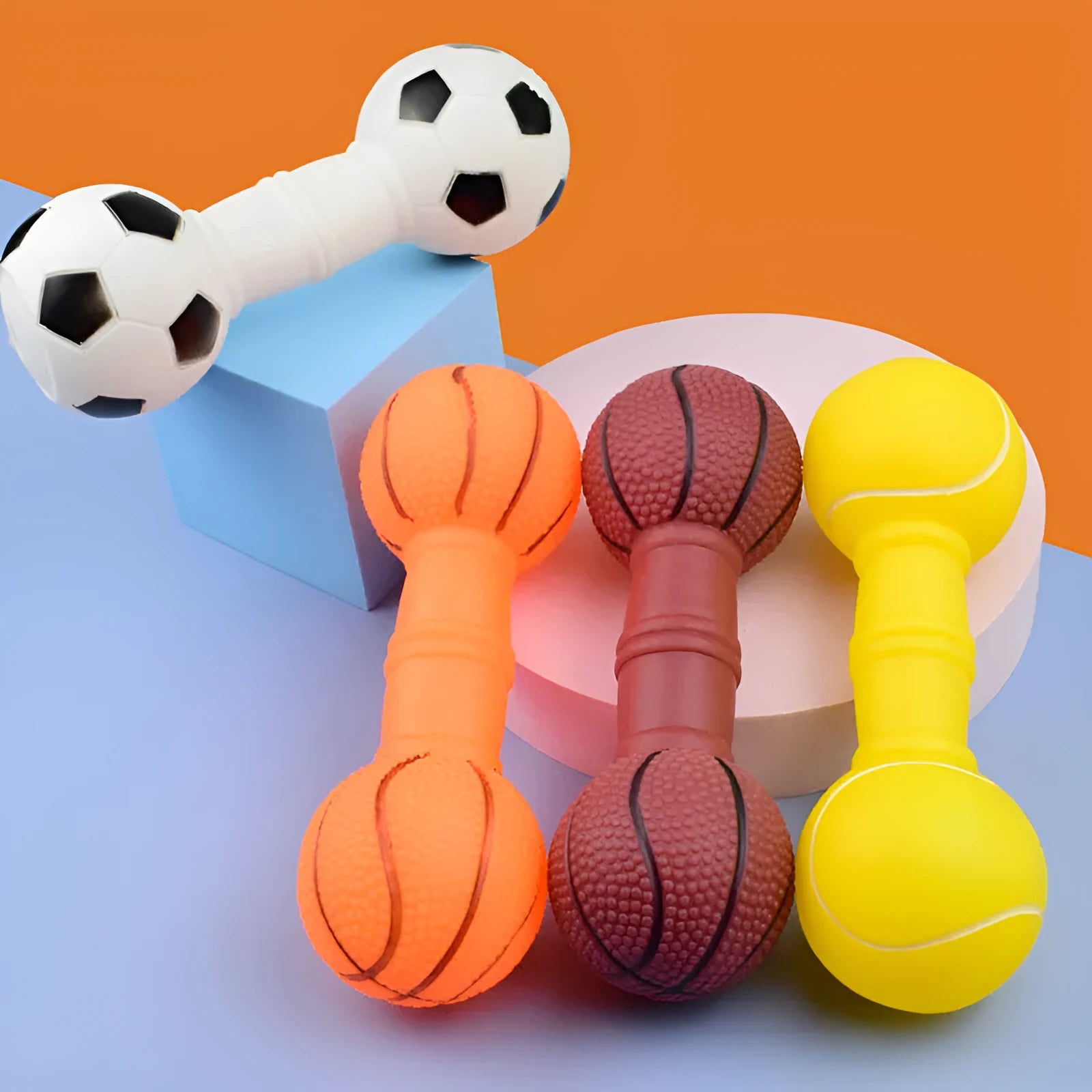 Brown orange white yellow PVC football dumbbell shaped squeaky dog chew toy on a plain background.