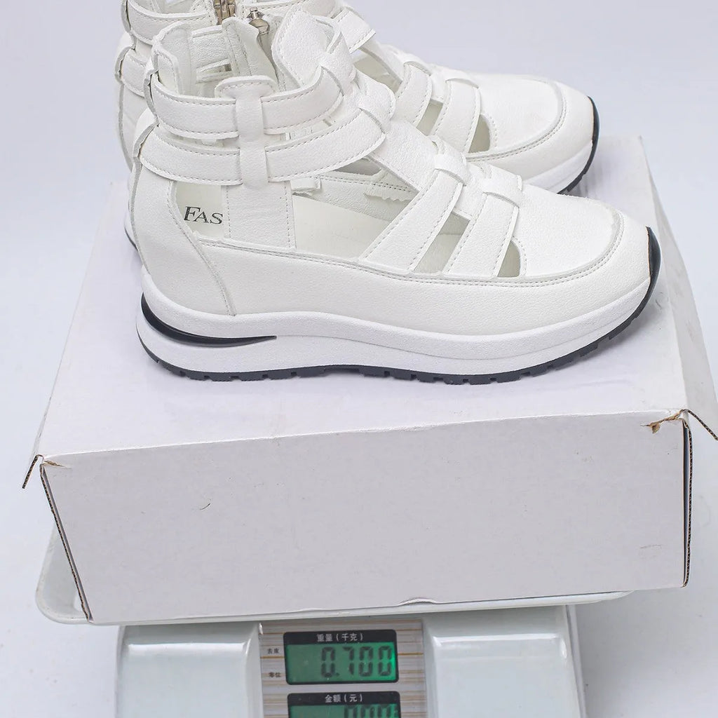 Women's black close-toed hollow-out platform sandals with Velcro strap on a white background