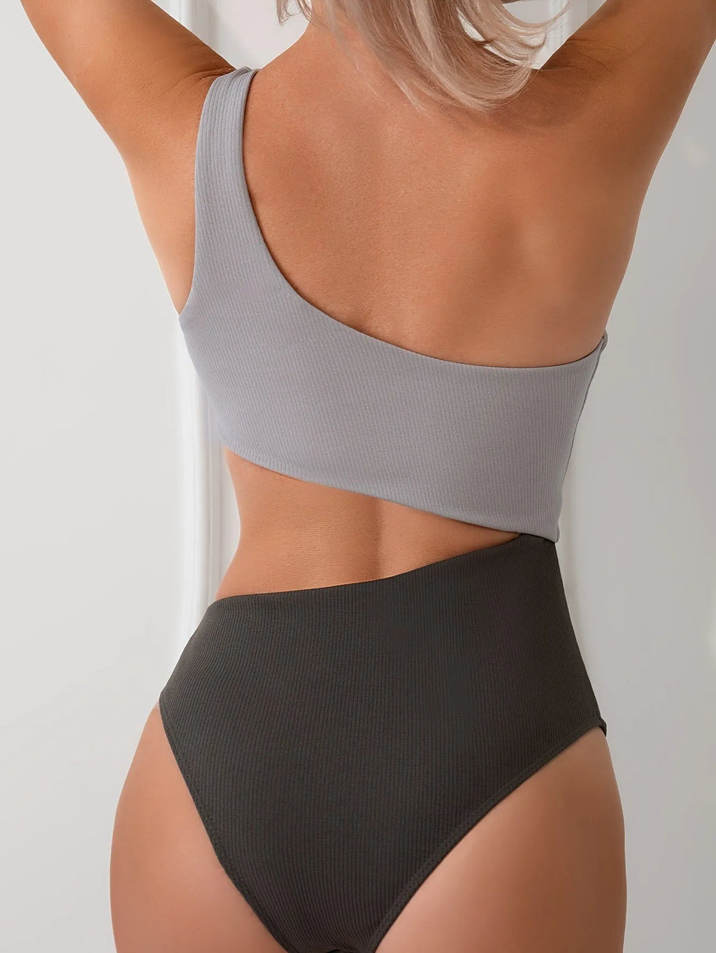 Women's light grey one-shoulder one-piece swimsuit made from polyester fabric
