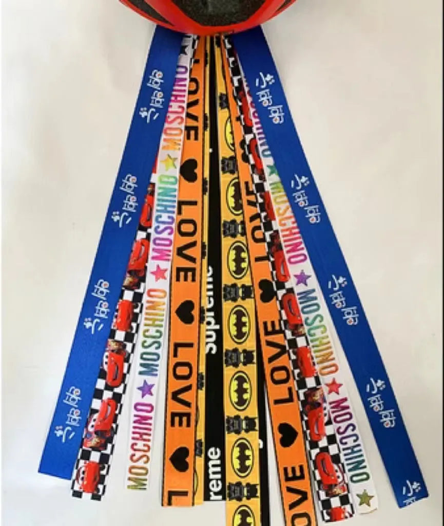 A colourful helmet streamer accessory for children's sports helmets and doll decoration.