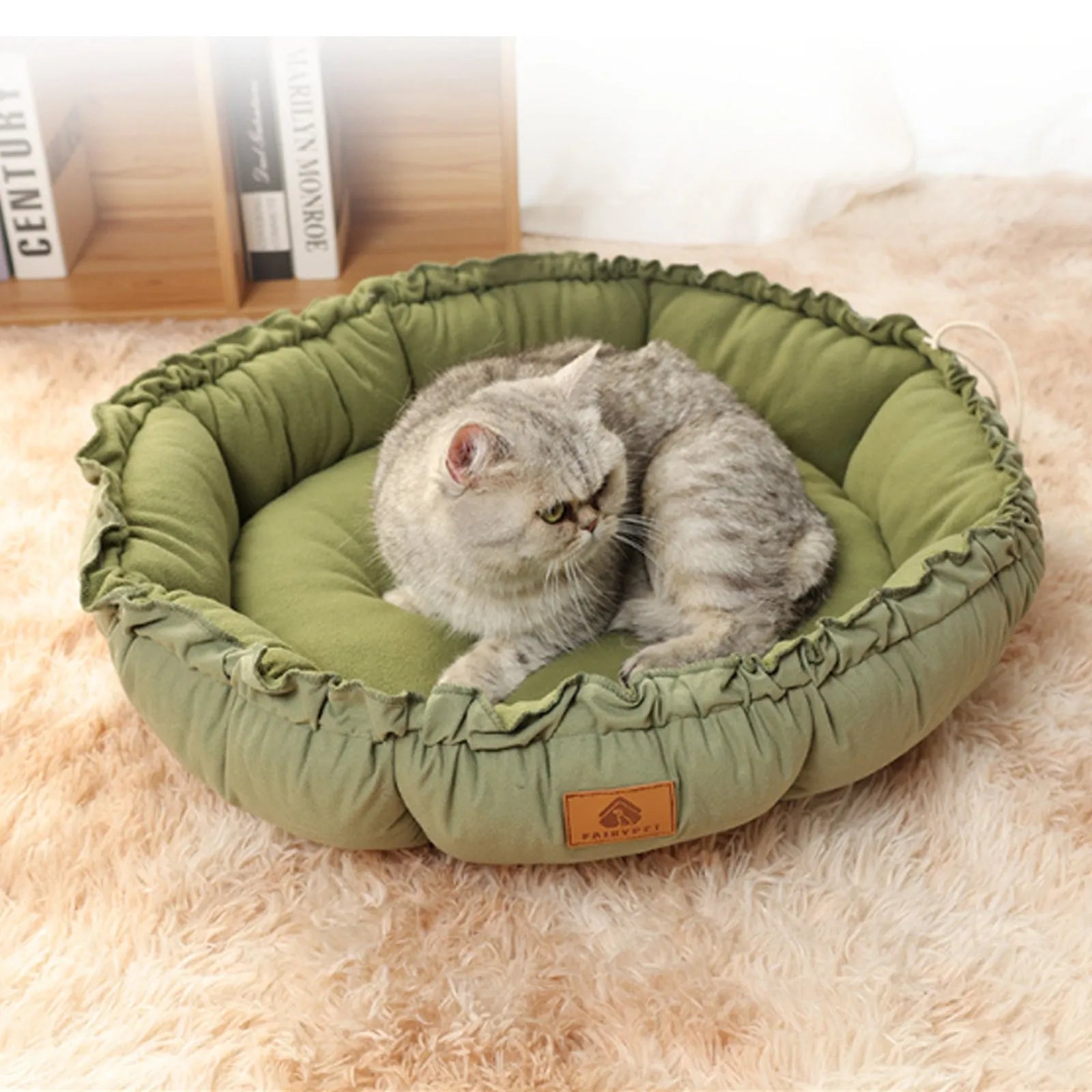 Grey reversible donut cat bed showing sherpa and velvet sides, suitable for indoor cats.
