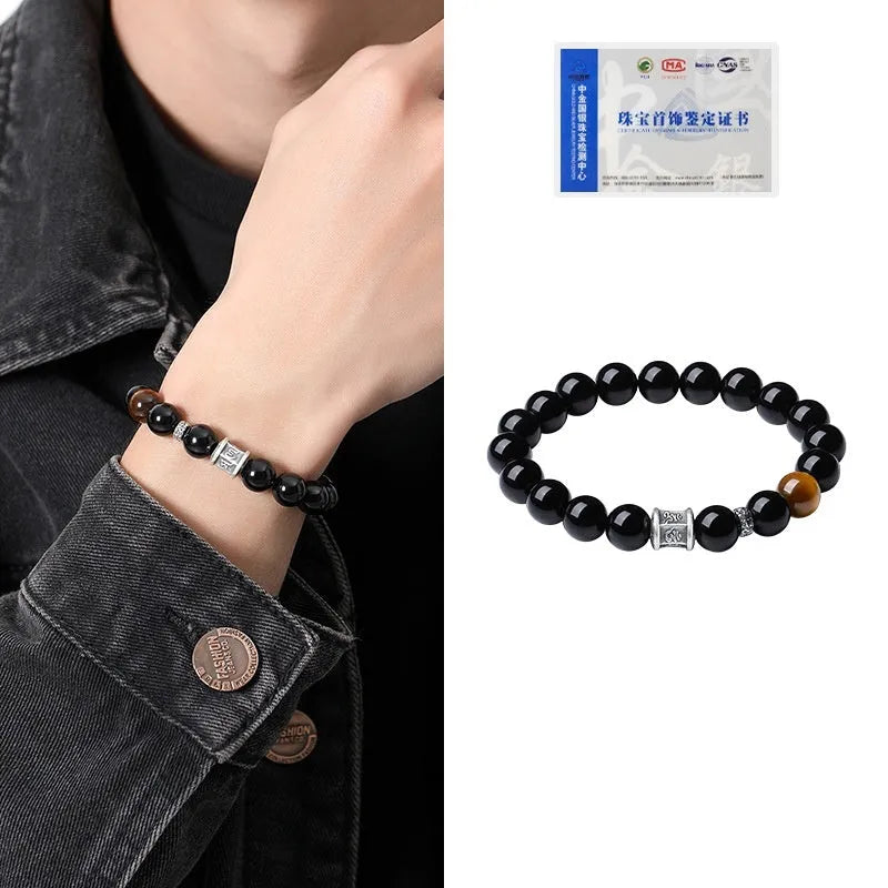Men's obsidian prayer wheel bracelet with 10mm beads on wrist