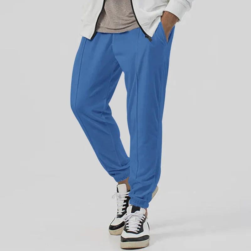 Men's grey track sweatpants with elastic waistband and straight-leg tapered fit