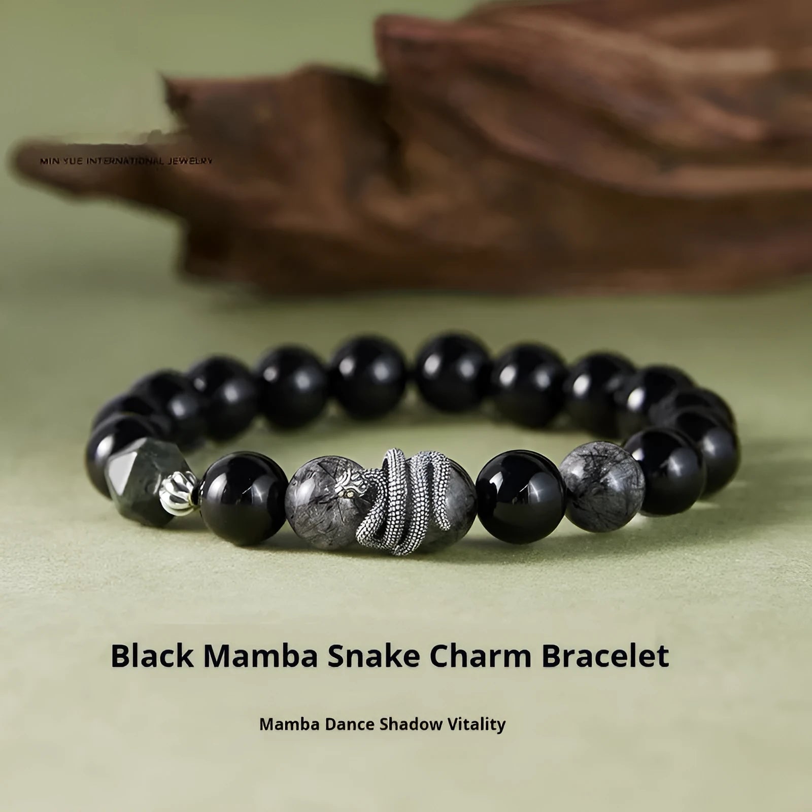 Men's S925 sterling silver bracelet with a black obsidian snake charm on a dark background.