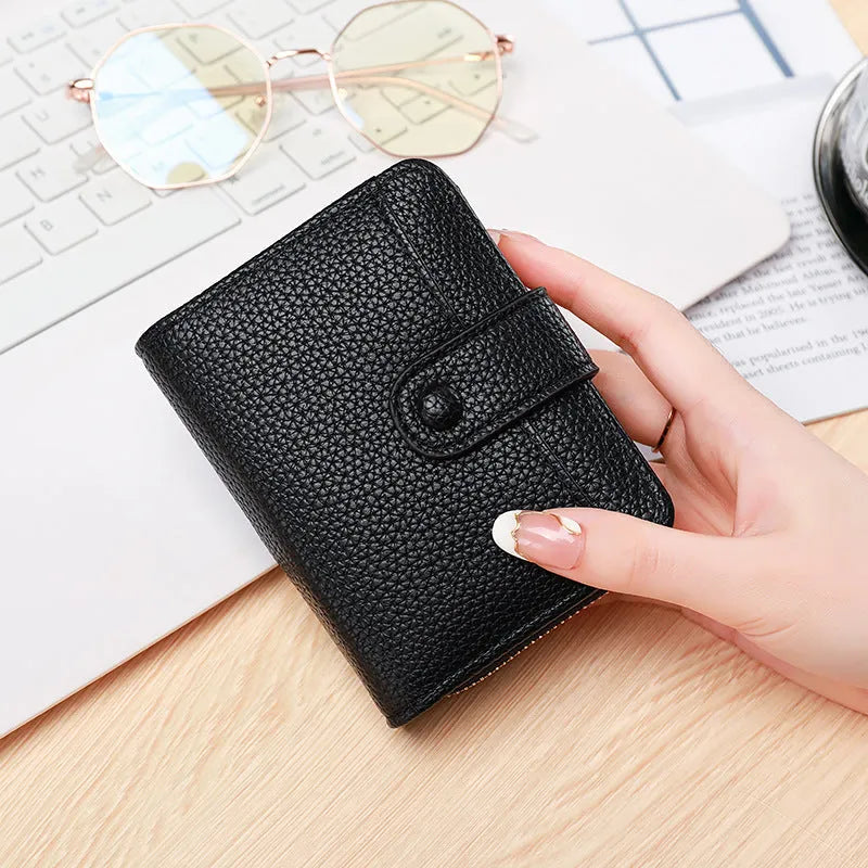 Ladies short pu leather wallet with lychee pattern in beige, showing two-fold design with card slots.