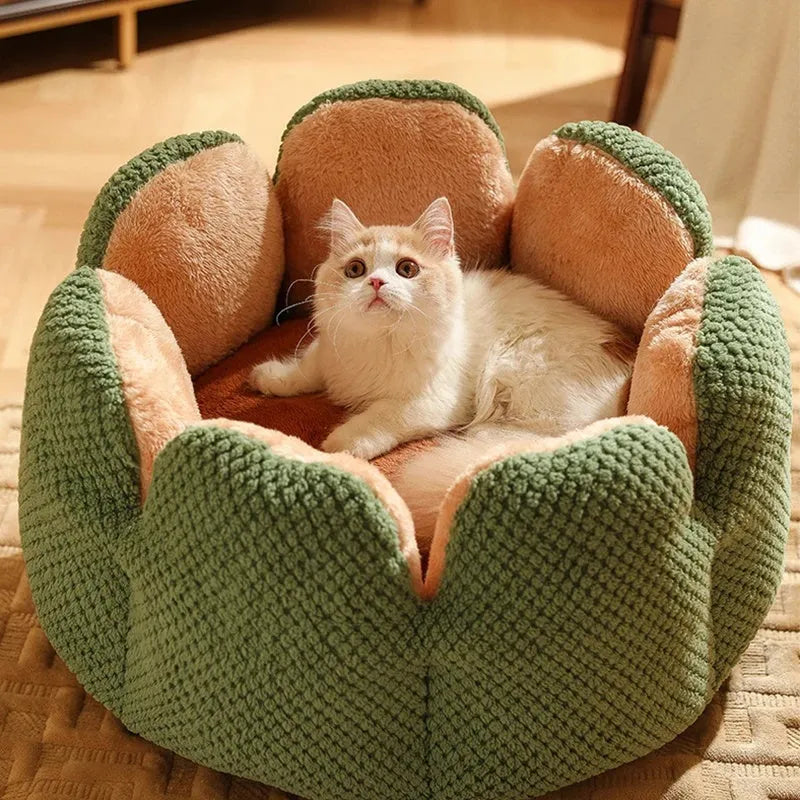 Green cactus petal shaped plush dog bed with a non-slip bottom on a wooden floor.