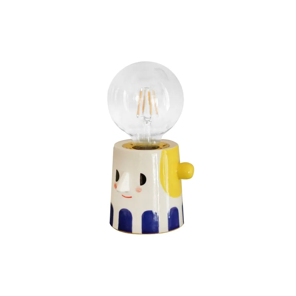 Handmade ceramic table lamp with ball headlight design on wooden surface
