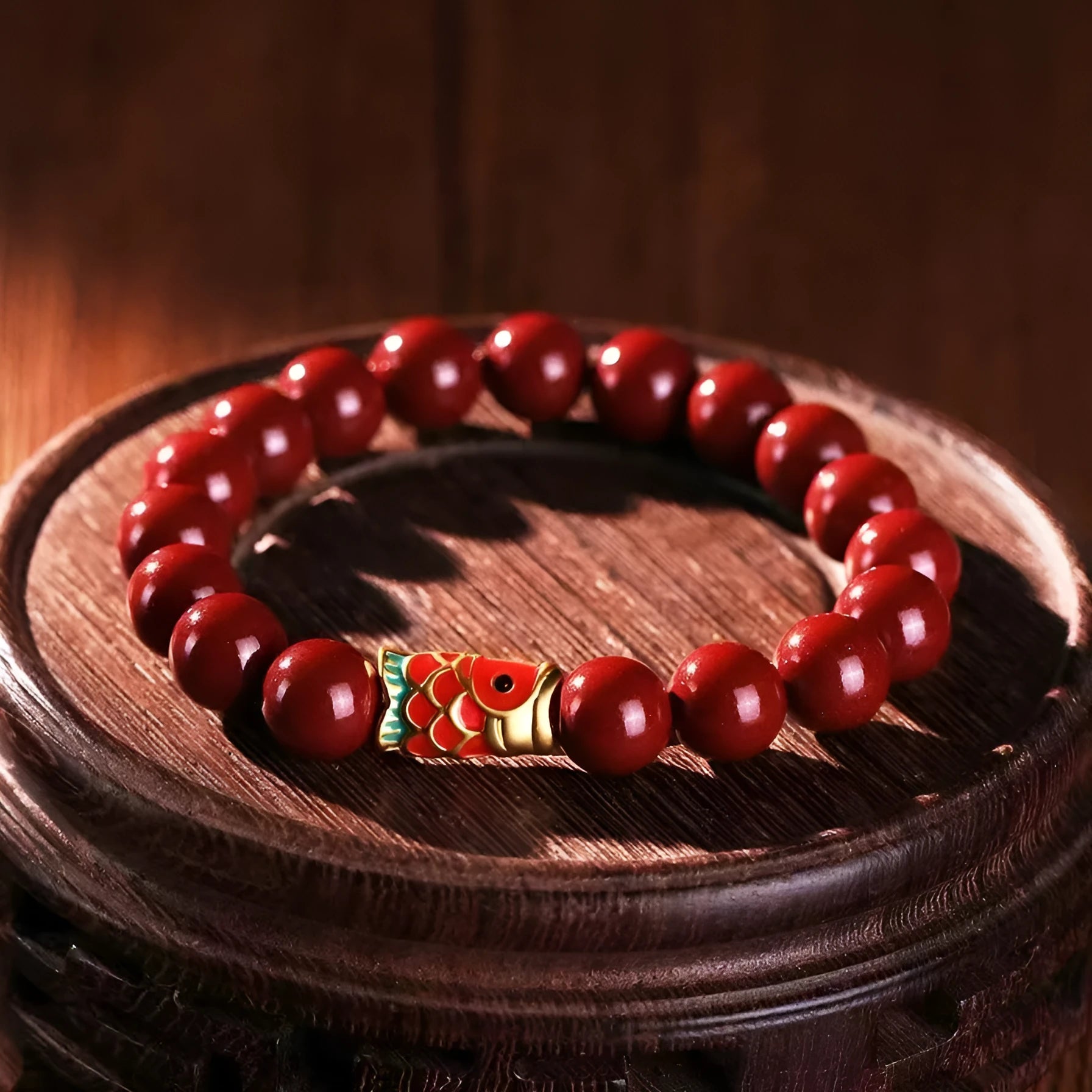 Natural cinnabar koi bracelet with golden ball charm in traditional Chinese style design