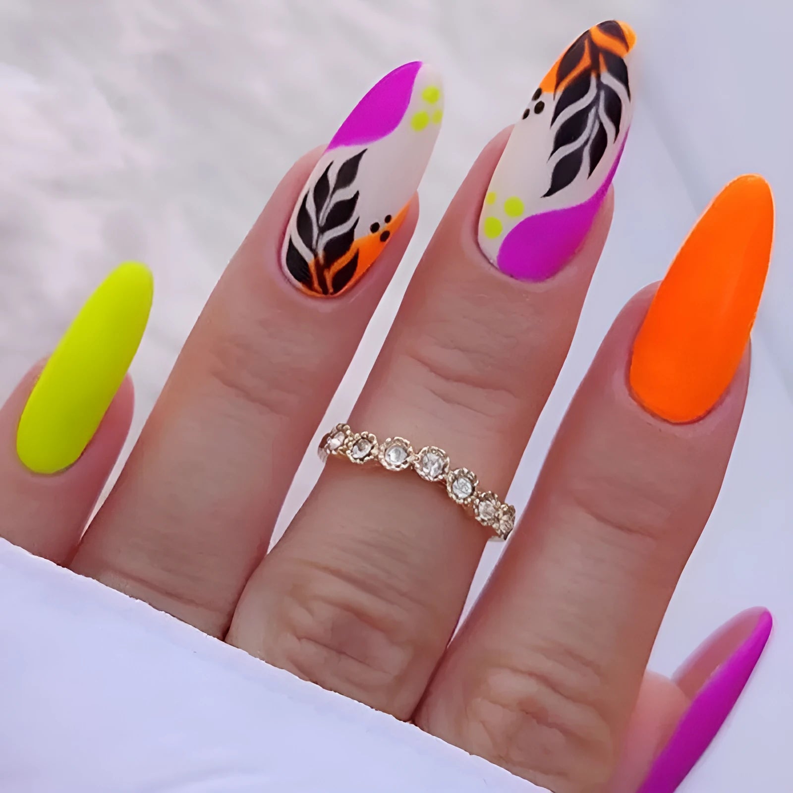 Wear Armour frosted finish nail stickers in medium almond shape showing four designs: French leaves, colourful plating, macarons, and leopard print.