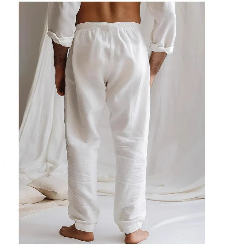 Men's loose straight-leg trousers in light blue with an elastic waistband and drawstring detail.