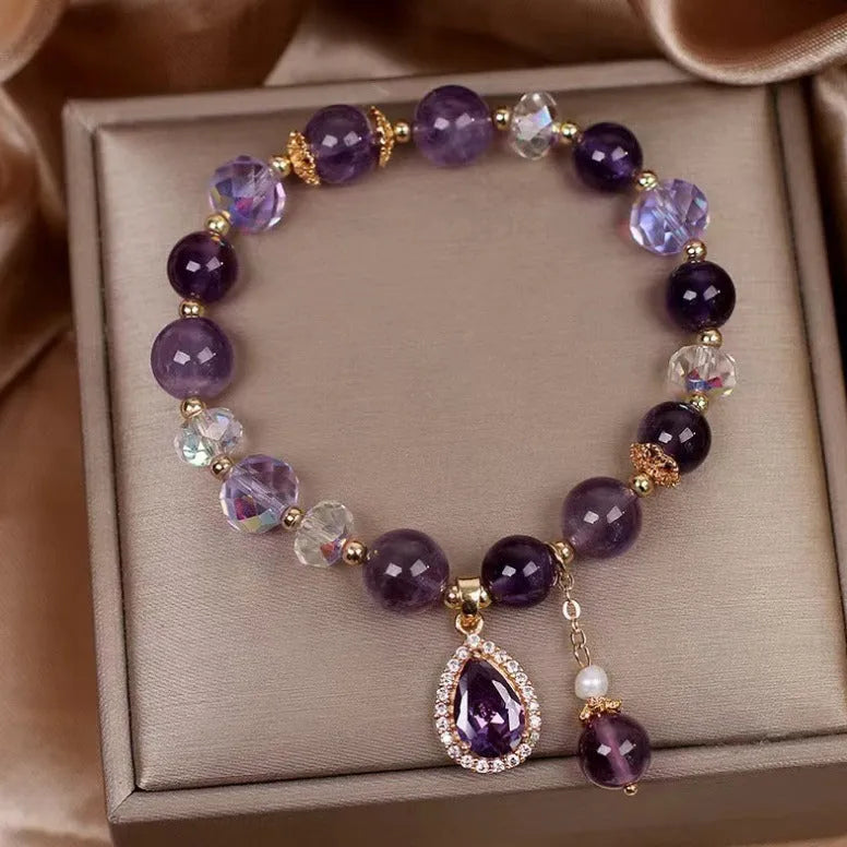 Close-up of a women's purple amethyst crystal bracelet with detailed micro inlay stone setting.