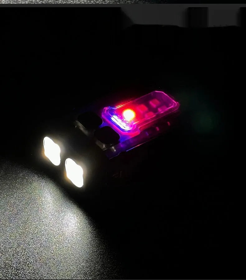 Portable mini tactical warning flashlight with USB charging cable on a backpack strap.