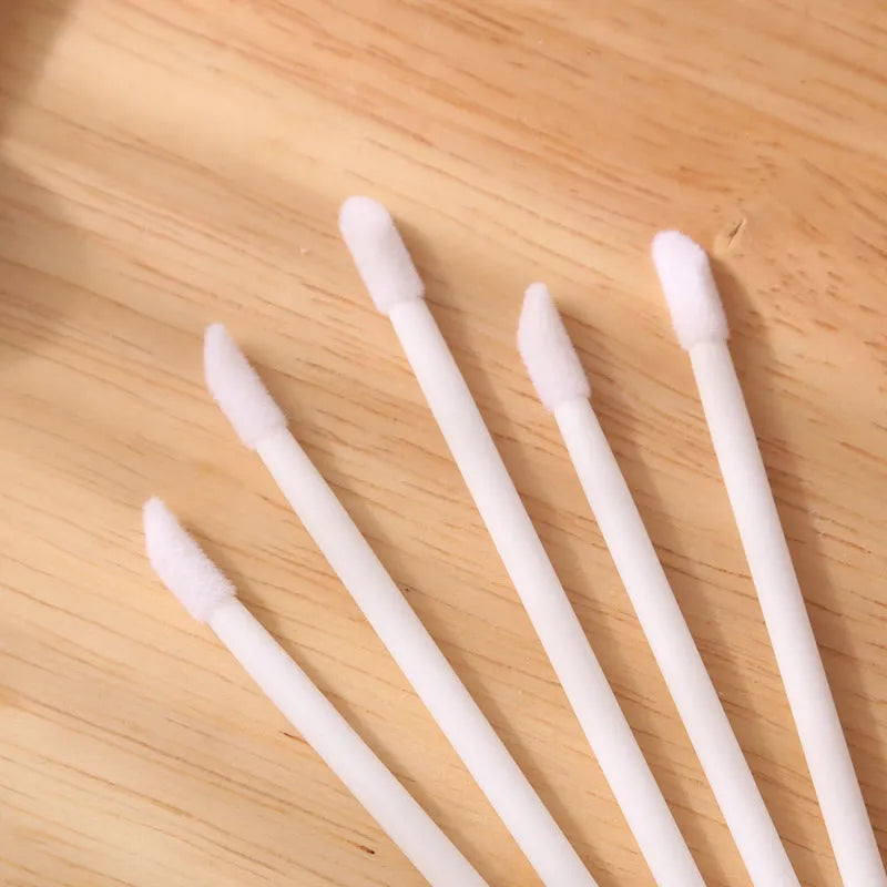 Pack of disposable lip brush wands with flocked brush tips and coloured handles.