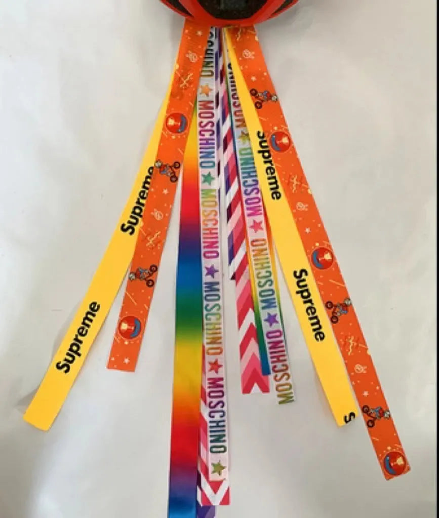A colourful helmet streamer accessory for children's sports helmets and doll decoration.
