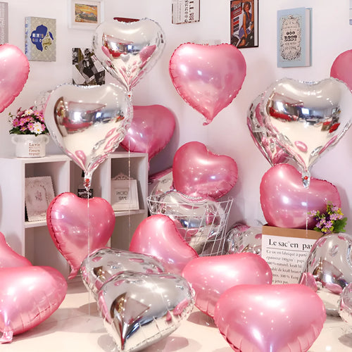 Five peach heart-shaped aluminium balloons in sparkling metallic colours: red, blue, rose, and silver.