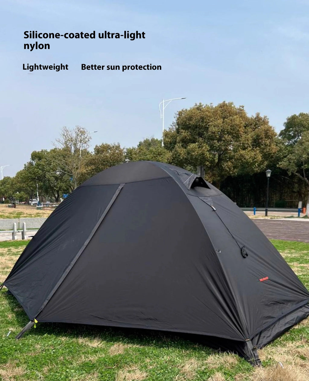 Black single person double account tent with aluminium poles set up outdoors