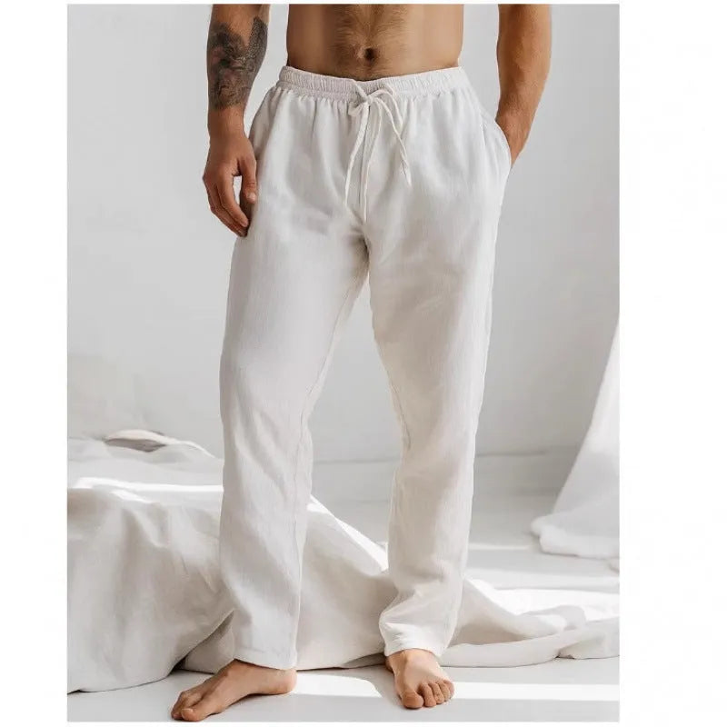 Men's loose straight-leg trousers in light blue with an elastic waistband and drawstring detail.