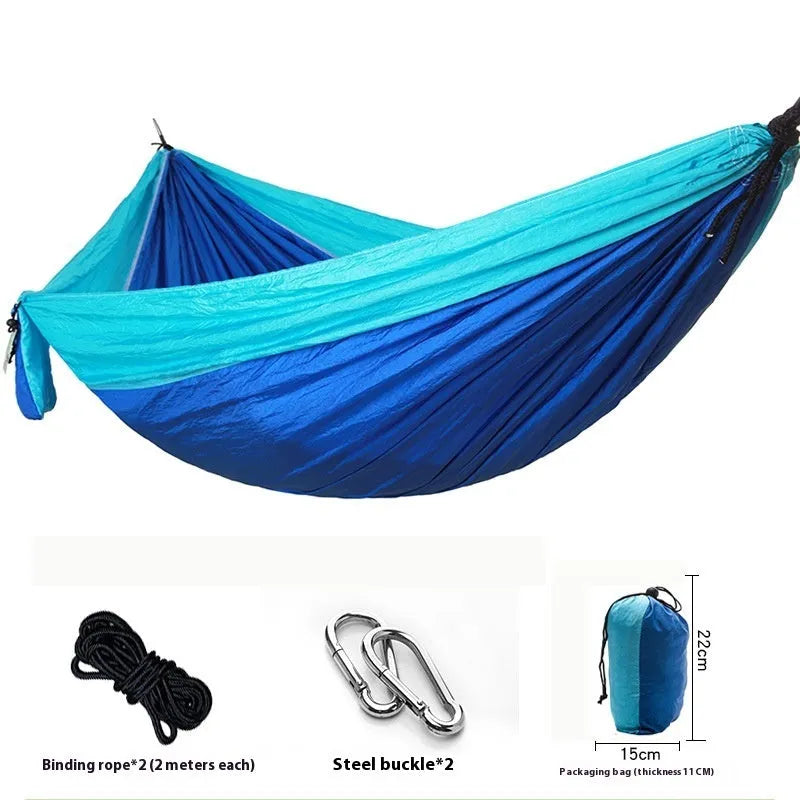 Double camping hammock with ropes and buckles shown in outdoor setting