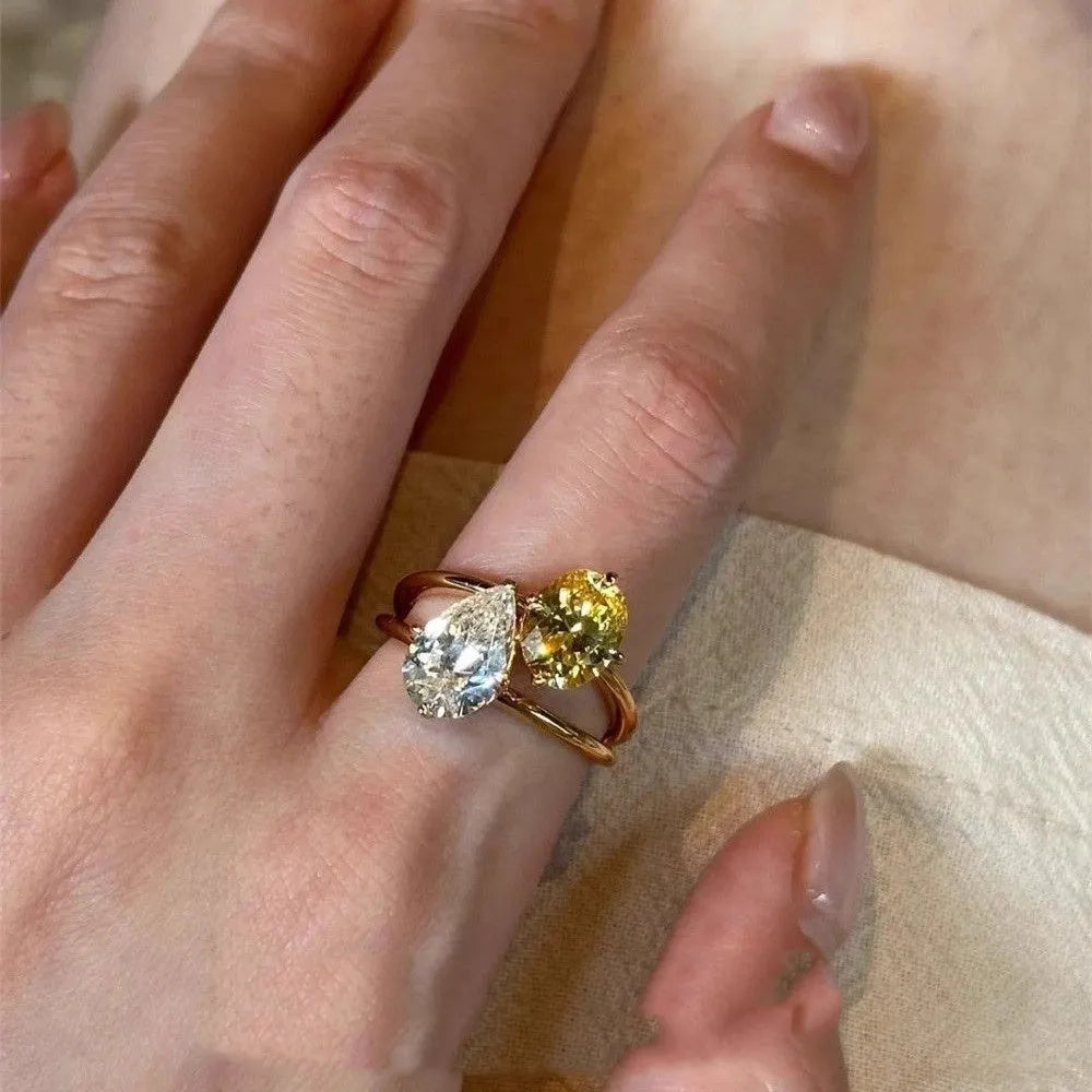 Open geometric ring with water drop shaped zircon stones in contrasting colours
