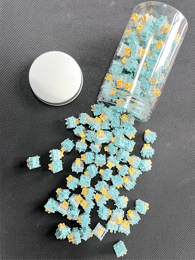 36 Sea Salt Lemon PRO Mute coloured mechanical keyboard switches laid out in rows.