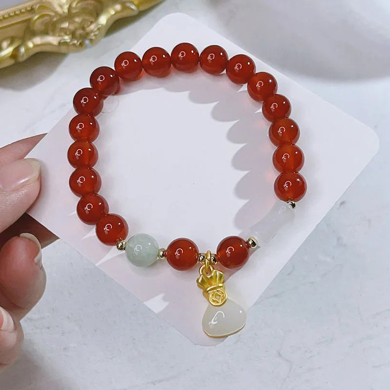 Handmade red agate bracelet with dragon and lucky bag Chinese designs for women.