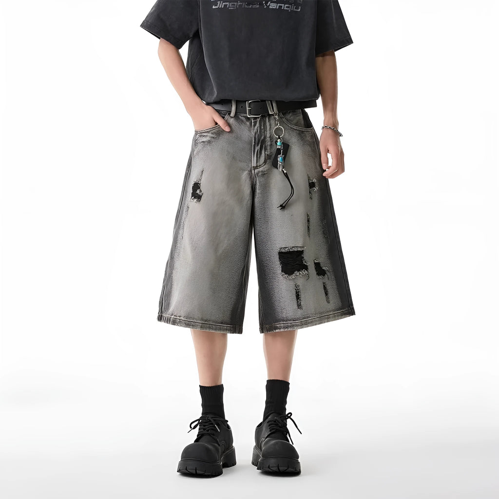 Grey water washed denim shorts with hole detailing and loose cropped fit