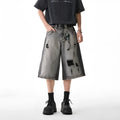 Grey water washed denim shorts with hole detailing and loose cropped fit