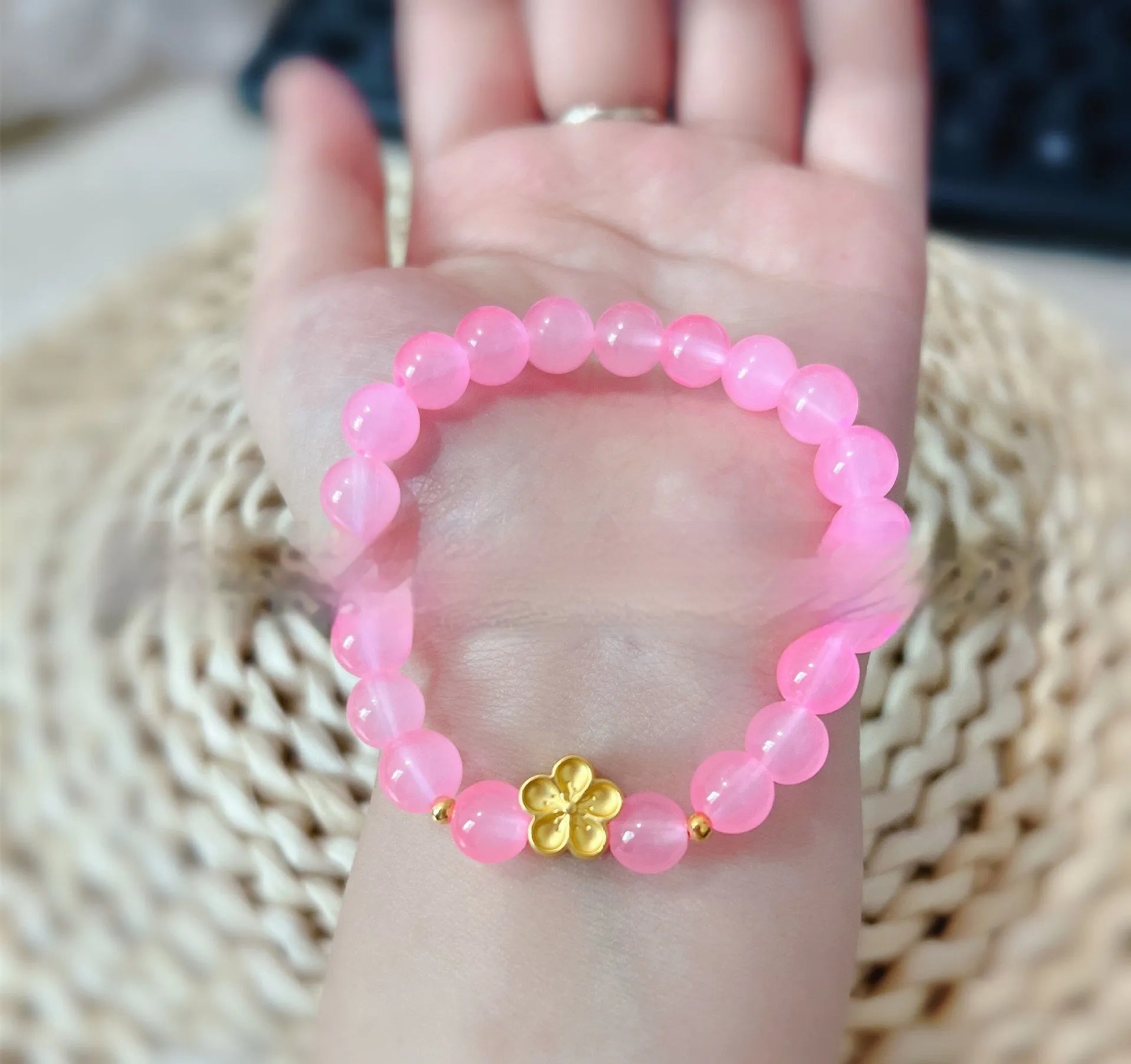 Aquamarine crystal bracelet with mixed materials including pink beads, white pearls, and peach blossom elements