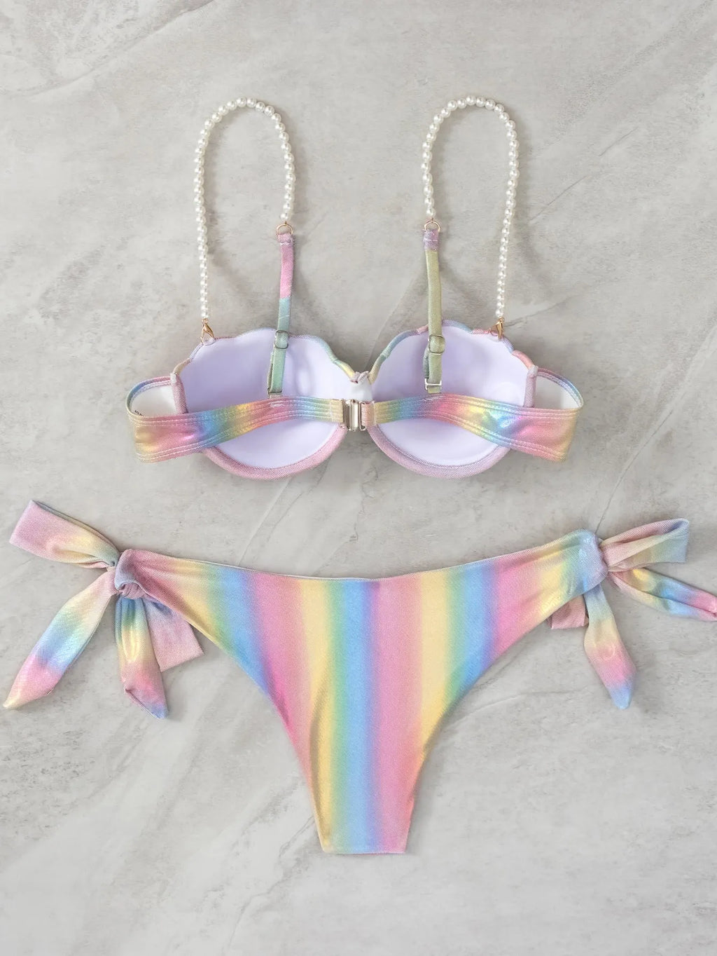 Women's shell rainbow coloured split bikini swimsuit with tied design on a mannequin.