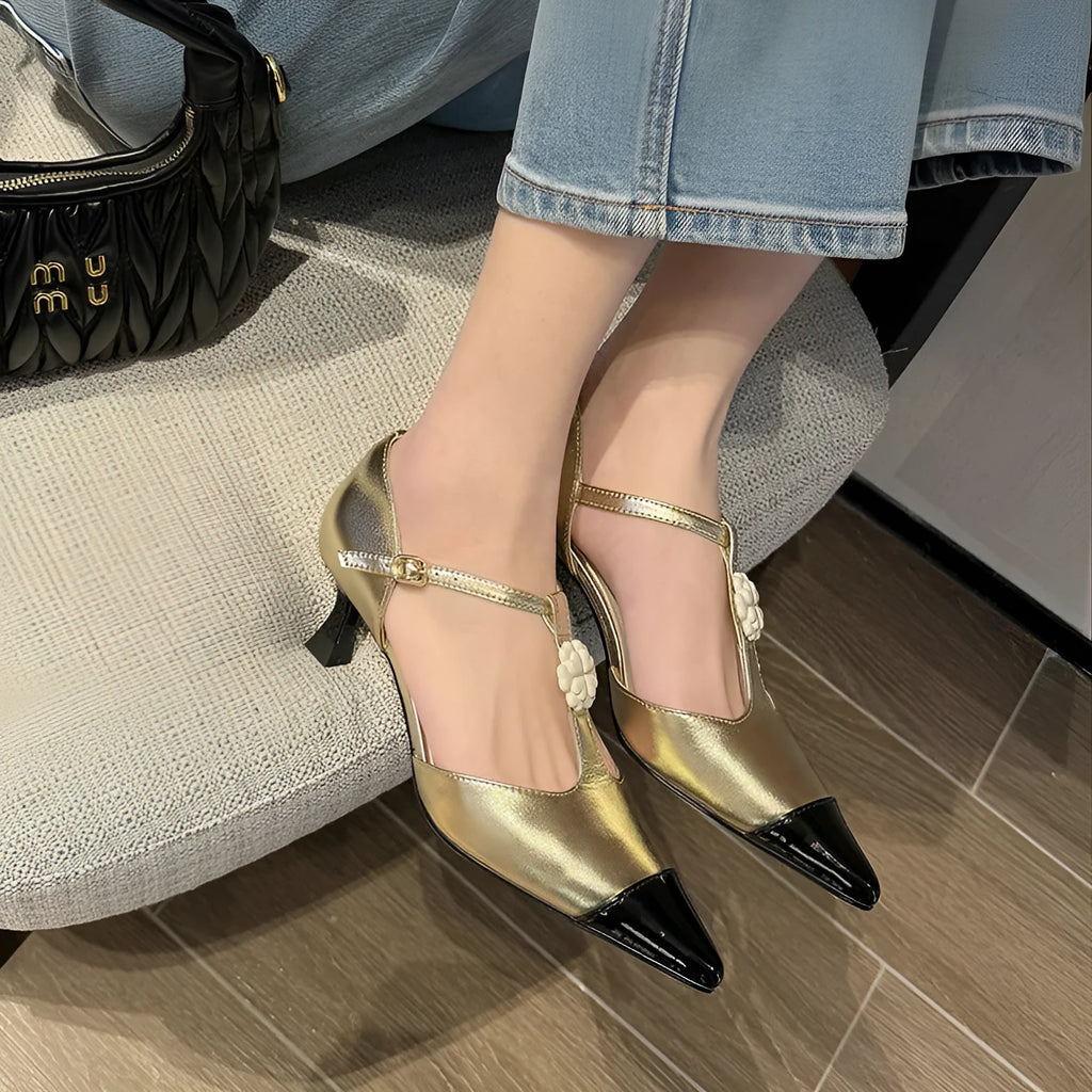 Gold women's stiletto heel shoe with pointed toe, flower buckle, and shallow mouth cut on a beef tendon sole.