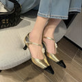 Gold women's stiletto heel shoe with pointed toe, flower buckle, and shallow mouth cut on a beef tendon sole.