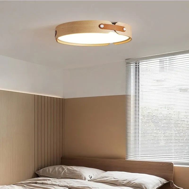 Japanese style wooden ceiling lamp with a round PMMA lampshade in warm light colour.