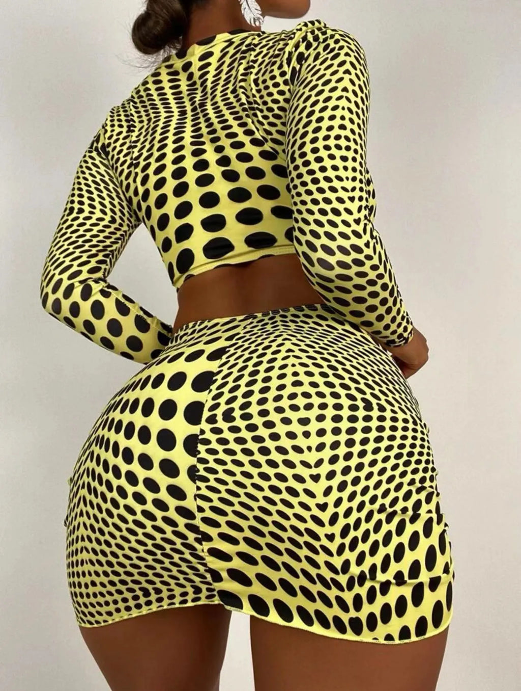 Women's green polka dot three-piece swimsuit set showing bra top and matching skirt