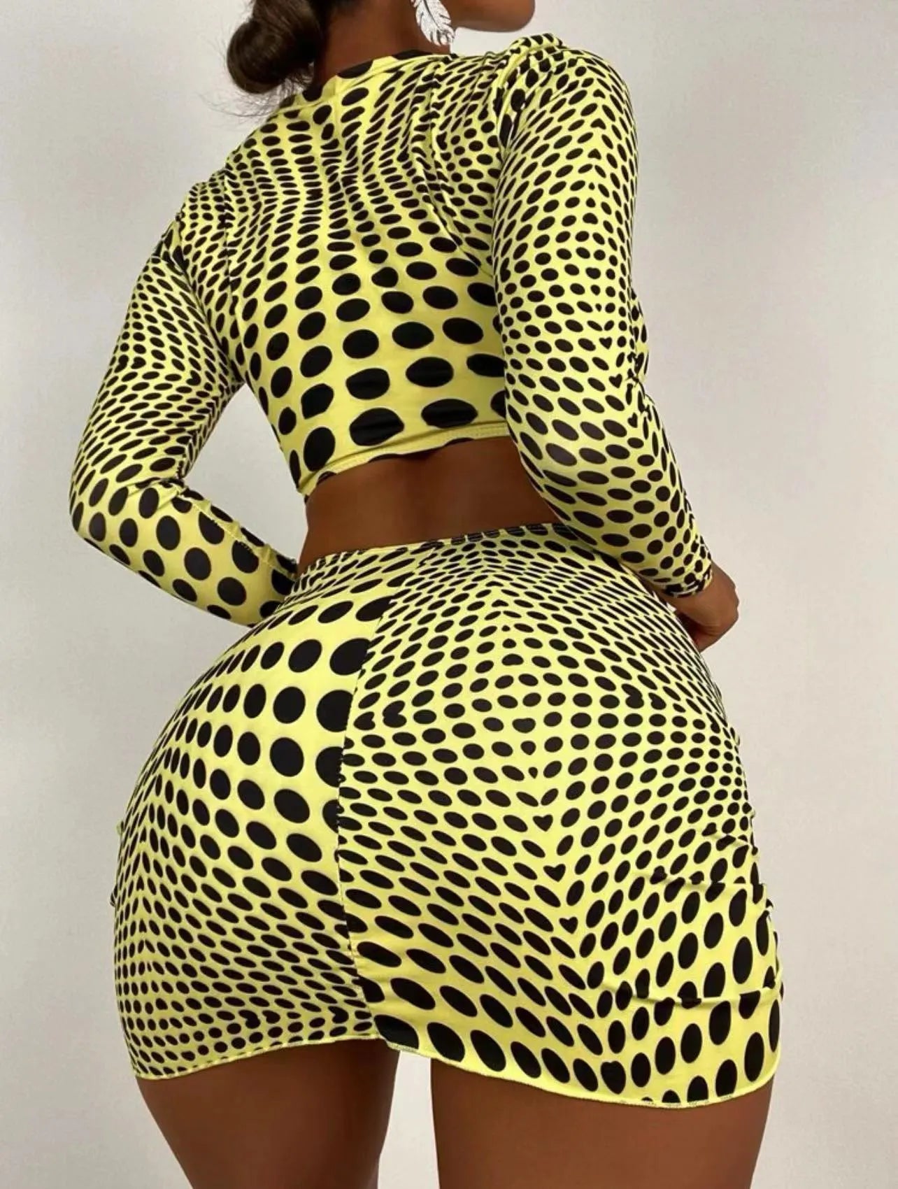 Women's green polka dot three-piece swimsuit set showing bra top and matching skirt