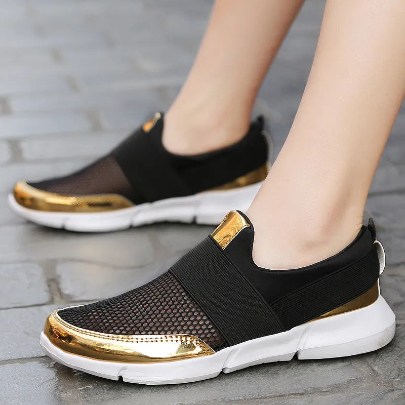 Blue, black, and grey women's low-top sneakers with a mesh lining and lightweight design.