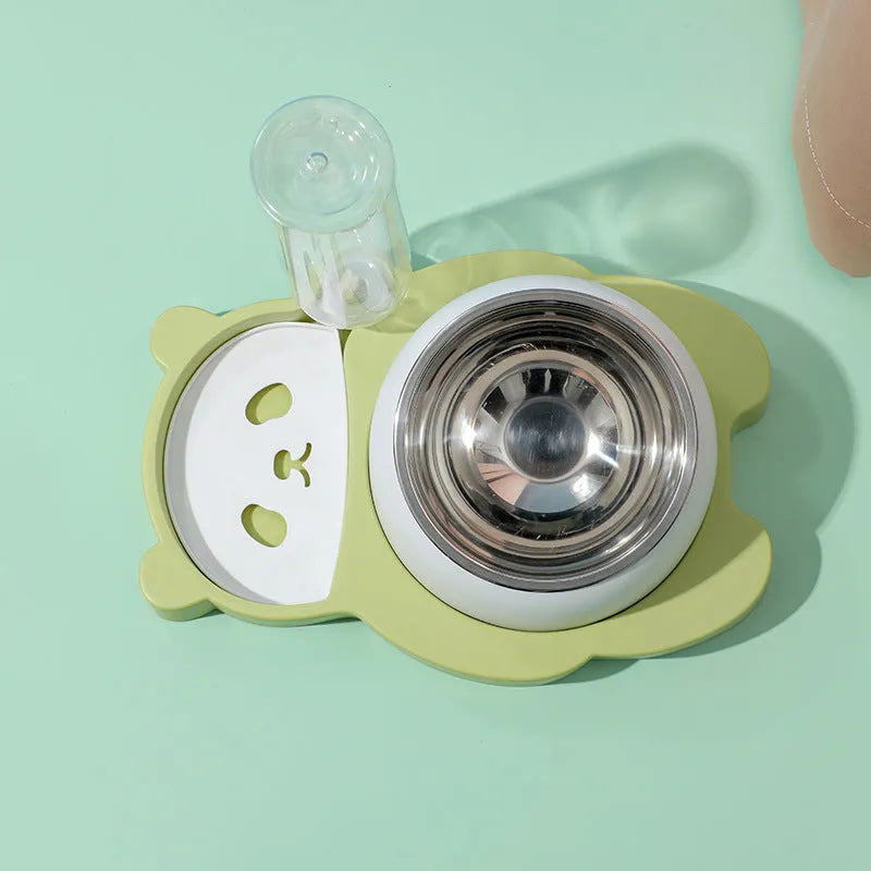 Grey panda-shaped pet feeder with tilted stainless steel bowls and a green automatic water bottle.