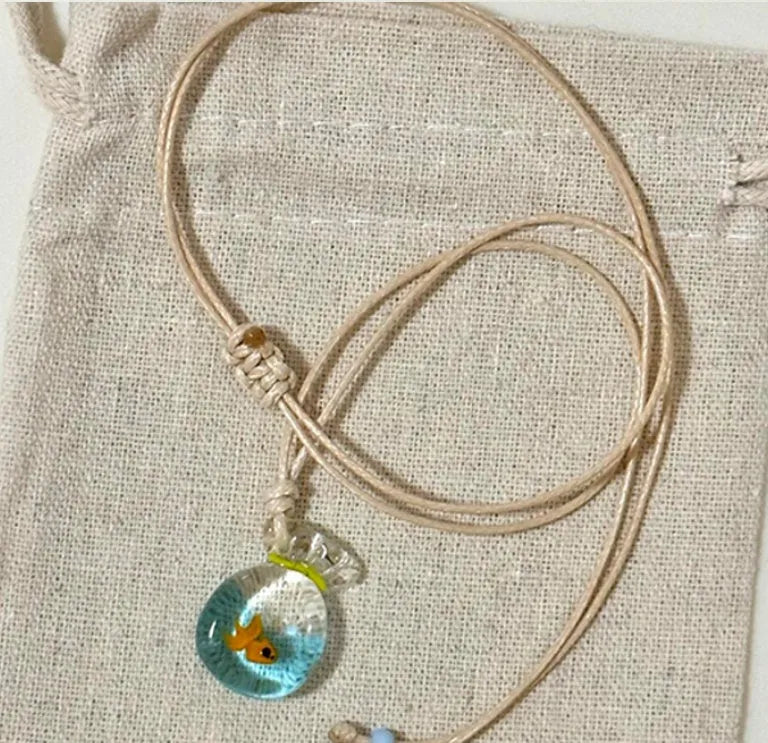 Women's necklace with coloured glaze pendant on a cotton and linen clavicle chain.
