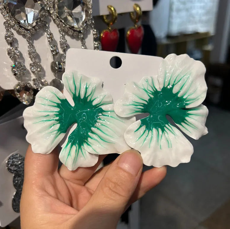 A pair of pastoral style alloy stud earrings with oil-spot glaze floral design in one of four colours.